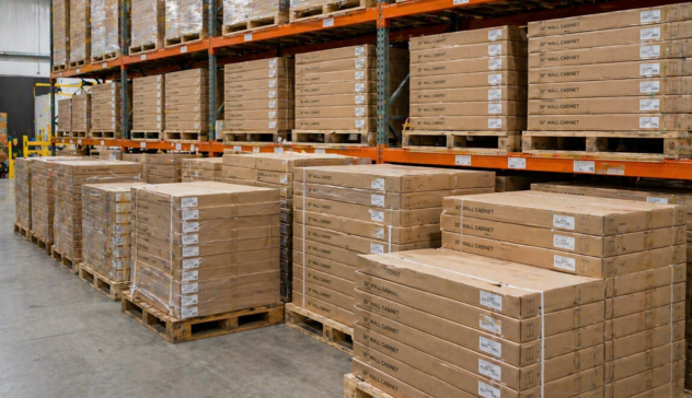 Flat-pack cabinet boxes stacked efficiently on pallets ready for delivery.