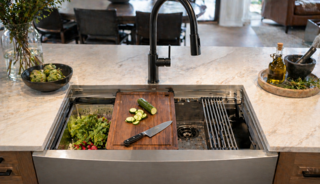 Workstation sink with built-in ledge and sliding accessories